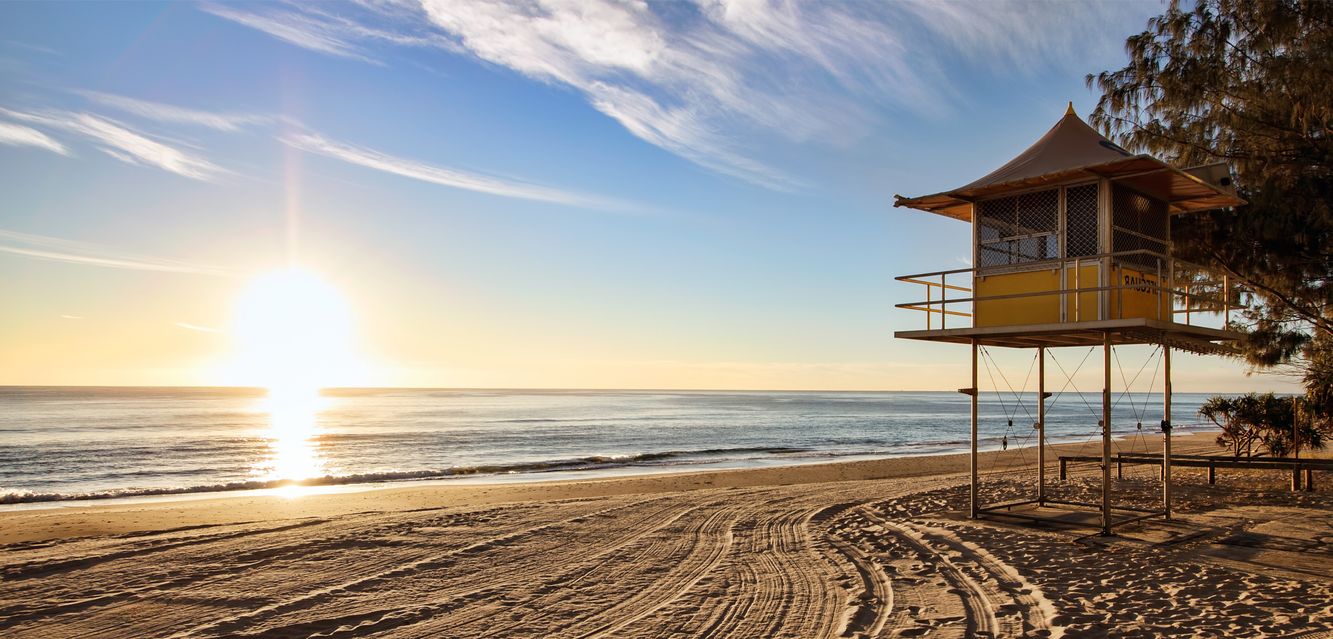Sunrise illuminates a lifeguard hut on Queensland’s Gold Coast.