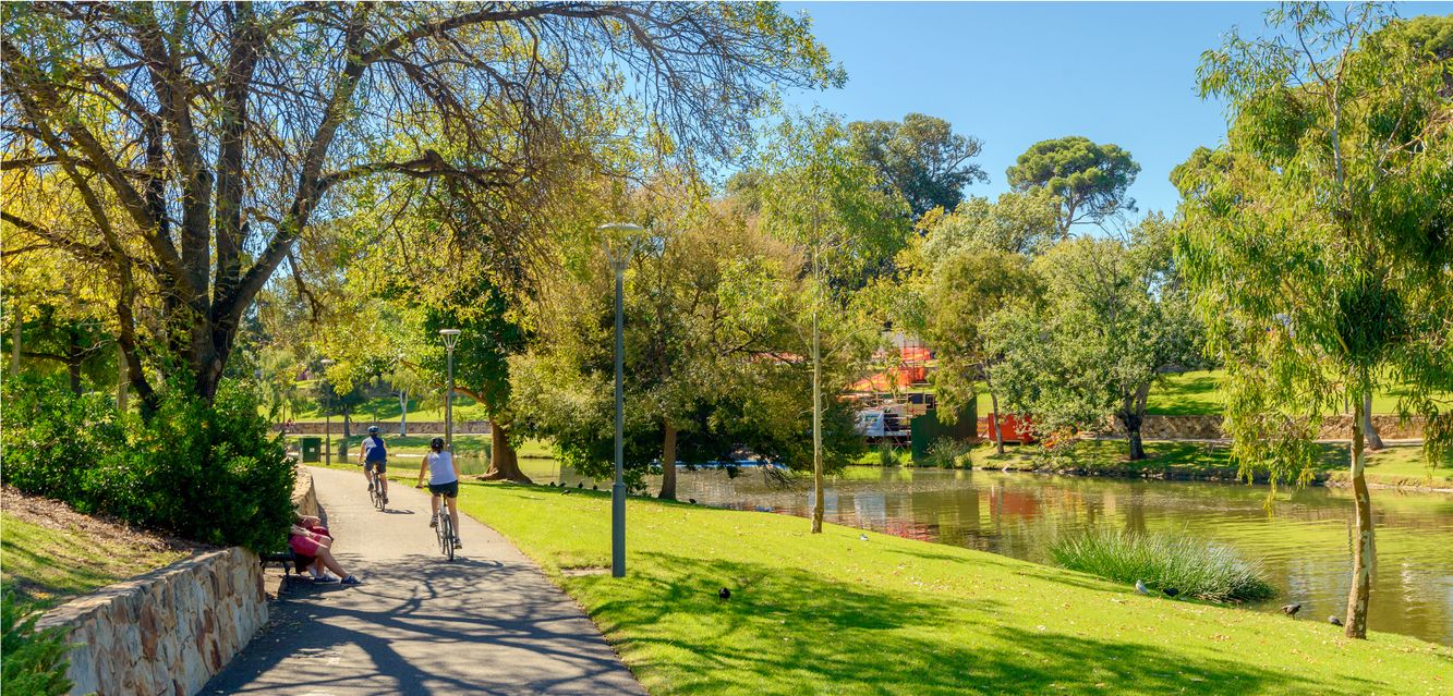 Cycling along the Torrens River track near Regency Park, Adelaide.