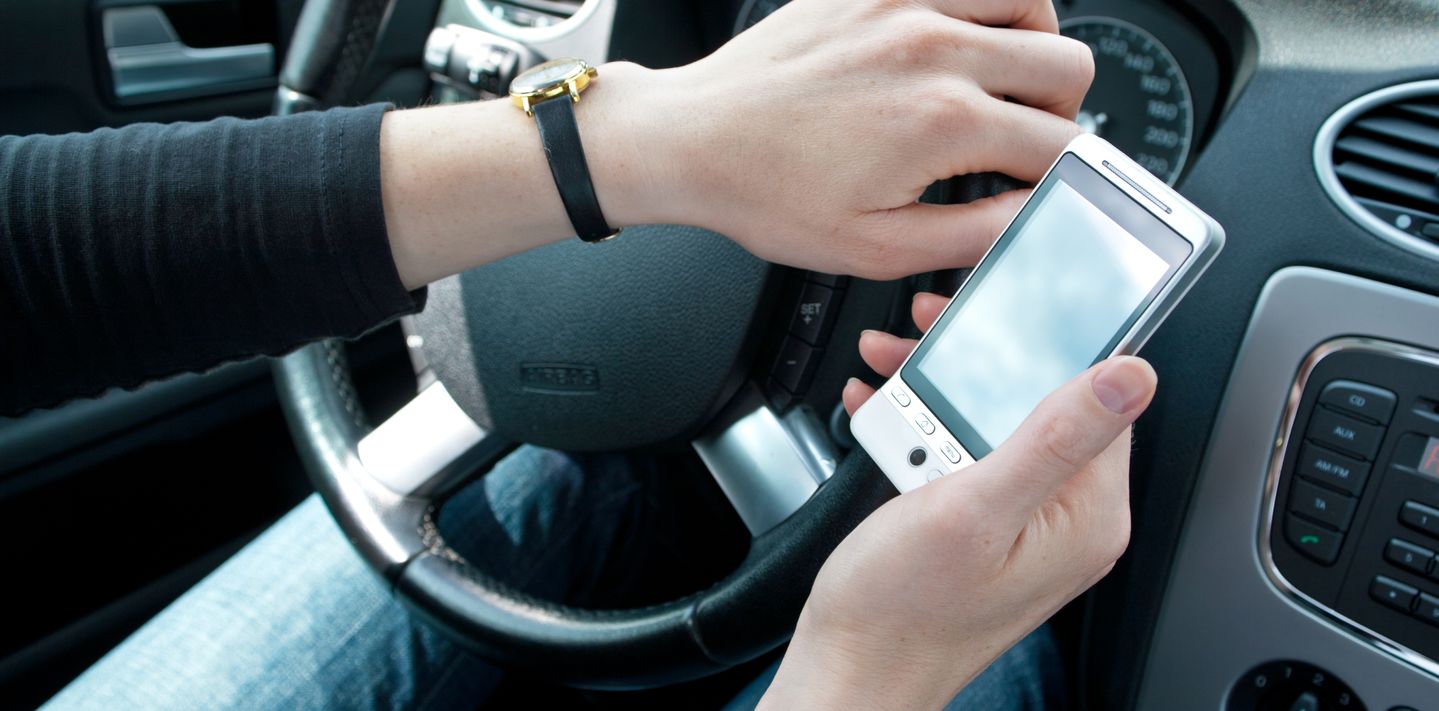 Driver using a mobile phone while driving.