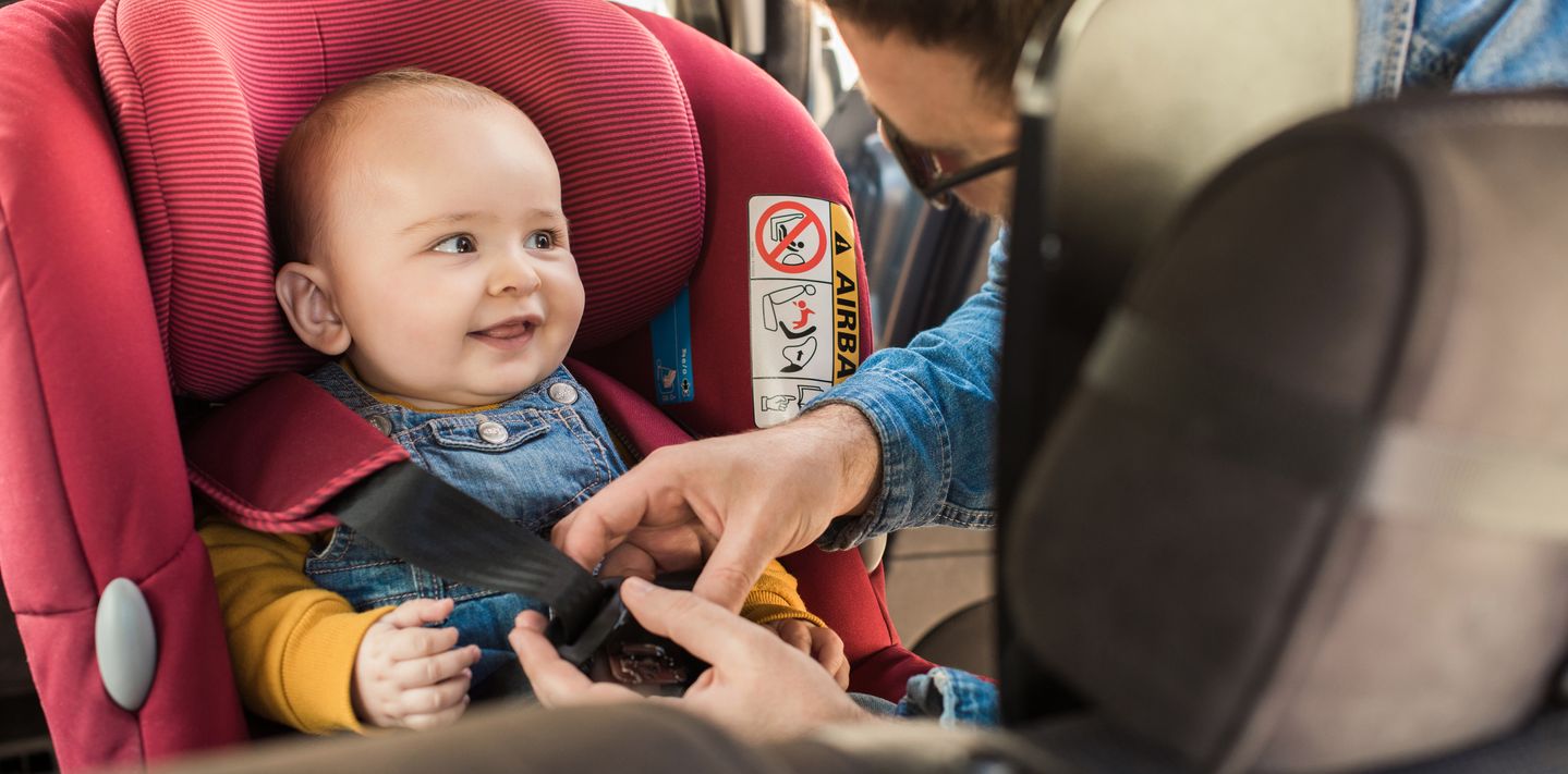 Baby in a baby seat in a car.