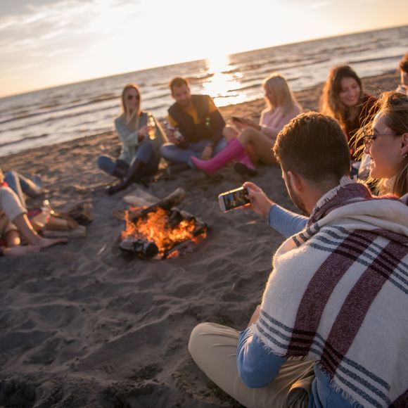 A group of friends have fun on the beach.
