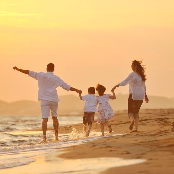 Family on the beach at sunset.