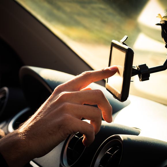 Man  adjusting  gps in car.
