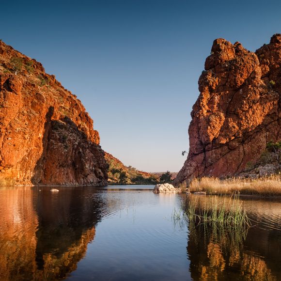 Reflections of rock formations at Glen Helen Gorge water hole.